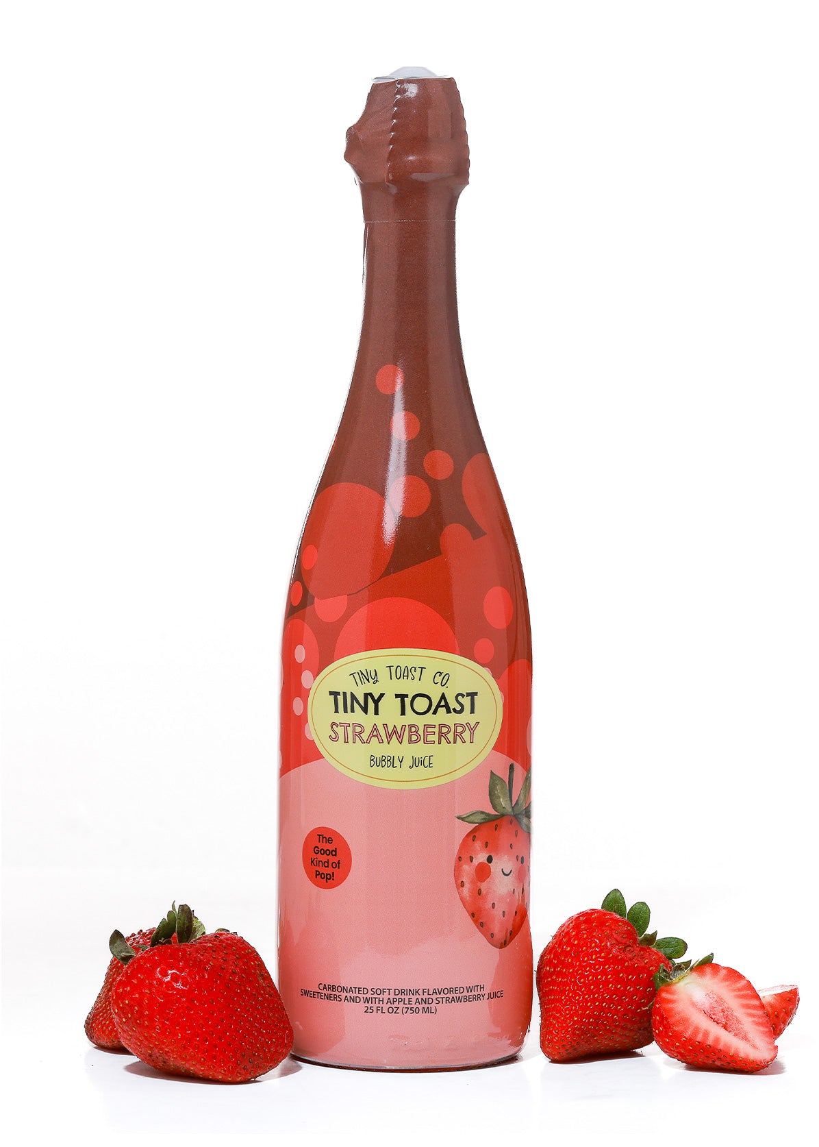 A bottle of Tiny Toast of Tiny Toast Strawberry Bubbly Juice, styled with fresh whole and sliced strawberries on a white background.